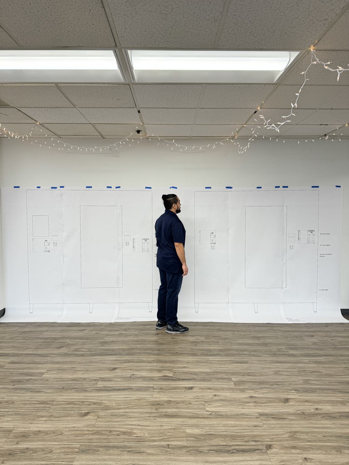 A participant marking up the life-size paper station
