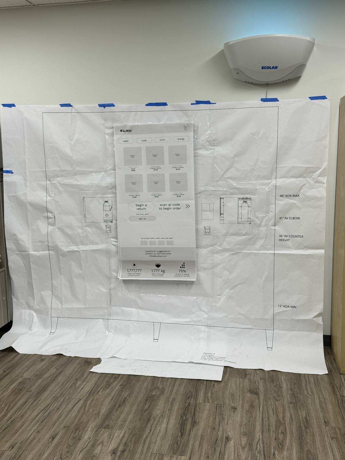 The life-size paper station taped up on site